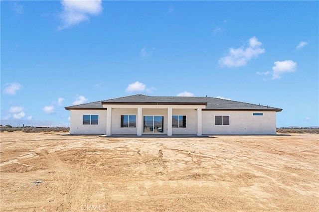 back of house featuring stucco siding
