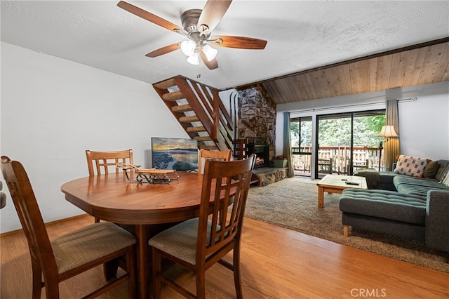 dining area featuring light wood-style floors, ceiling fan, and vaulted ceiling