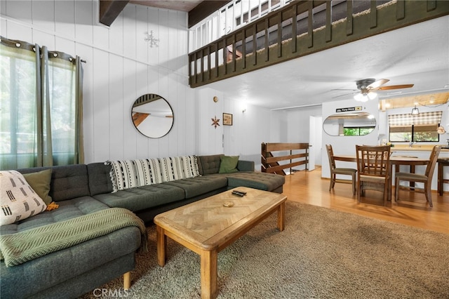 living room with wood finished floors and ceiling fan