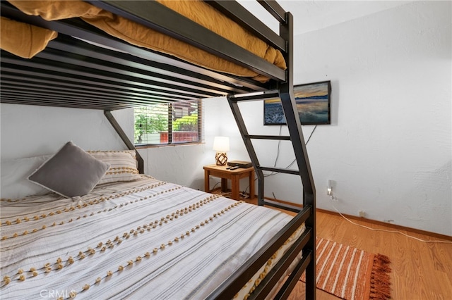 bedroom featuring wood finished floors