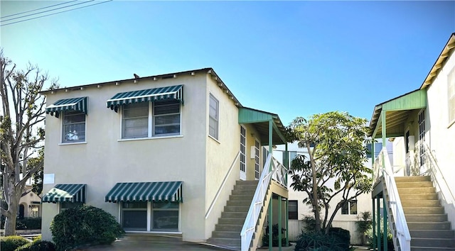 view of property exterior featuring stairway and stucco siding