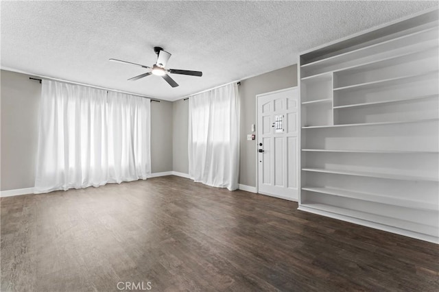 unfurnished living room featuring a textured ceiling, ceiling fan, wood finished floors, and baseboards