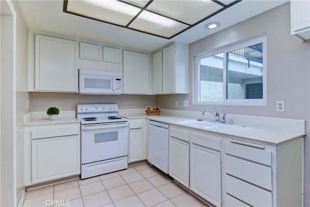 kitchen with white cabinetry, a sink, light countertops, light tile patterned flooring, and white appliances