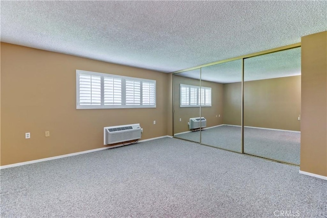 unfurnished bedroom with a textured ceiling, a closet, carpet floors, and baseboards