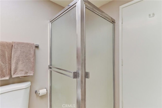 full bath with a shower stall and toilet