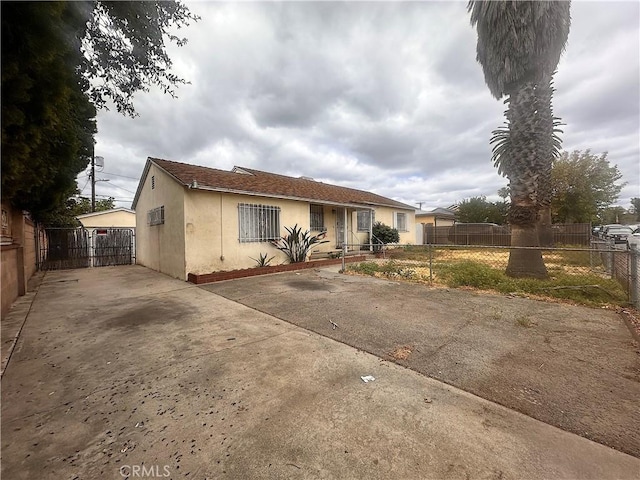 view of front of home featuring stucco siding and fence