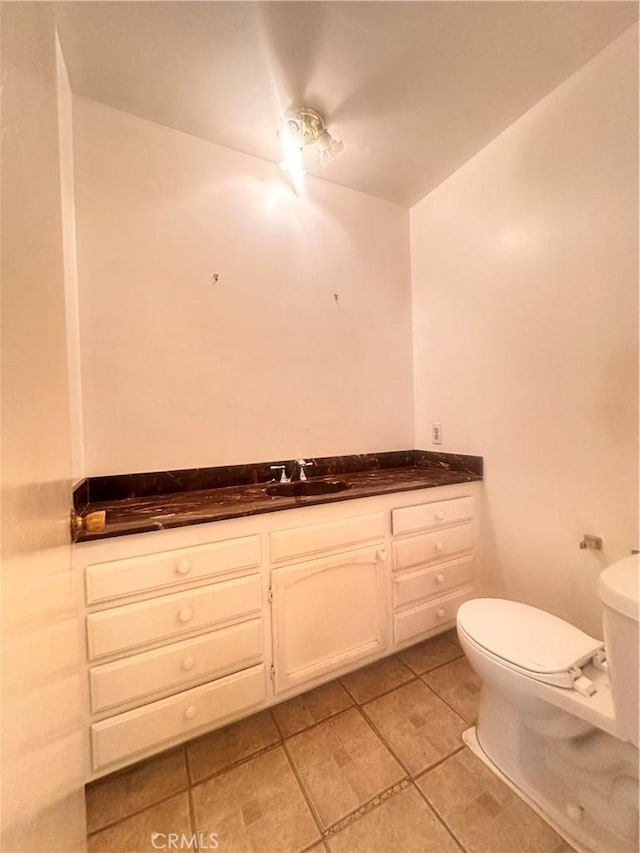 bathroom with vanity, toilet, and tile patterned flooring