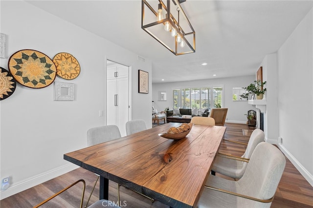 dining area with baseboards, recessed lighting, and wood finished floors