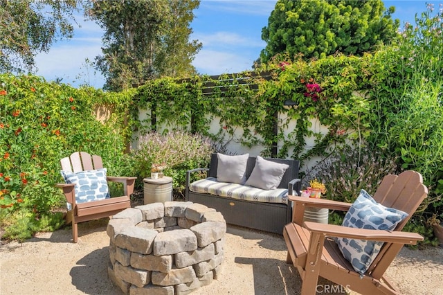 view of patio / terrace with an outdoor living space with a fire pit and fence private yard
