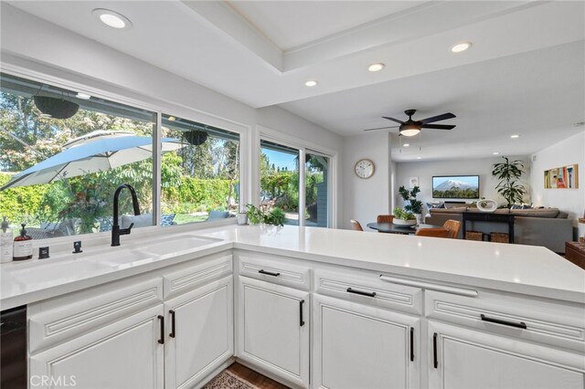 kitchen with recessed lighting, a sink, ceiling fan, white cabinetry, and light countertops