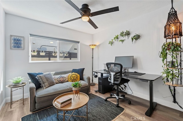 office area featuring ceiling fan, wood finished floors, and baseboards