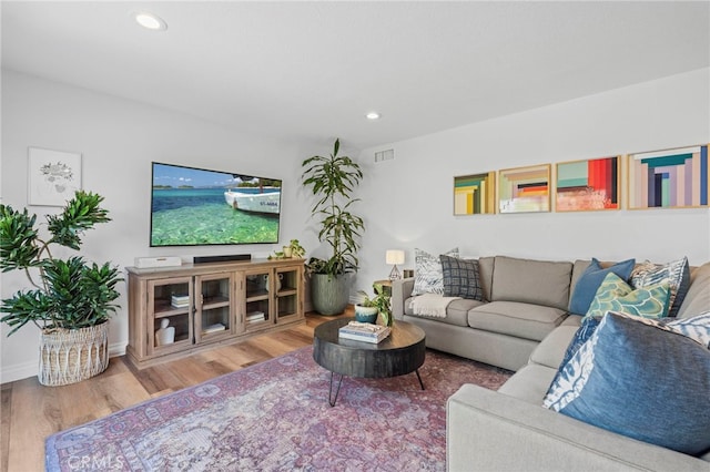 living area featuring visible vents, wood finished floors, and recessed lighting