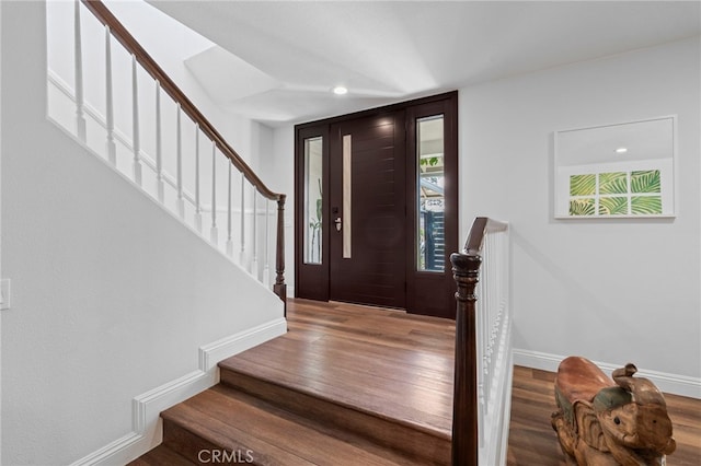 entrance foyer featuring recessed lighting, stairway, wood finished floors, and baseboards