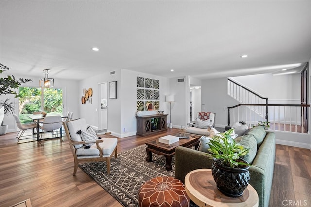 living room with recessed lighting, stairway, wood finished floors, and baseboards