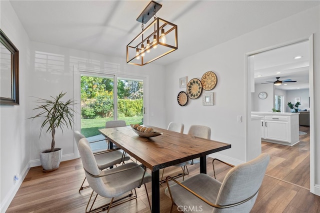 dining area with light wood-type flooring, recessed lighting, a ceiling fan, and baseboards