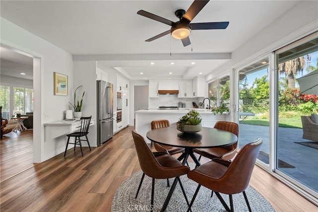 dining room featuring wood finished floors, a ceiling fan, and recessed lighting