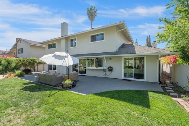 back of property with stucco siding, a chimney, a patio area, and an outdoor hangout area