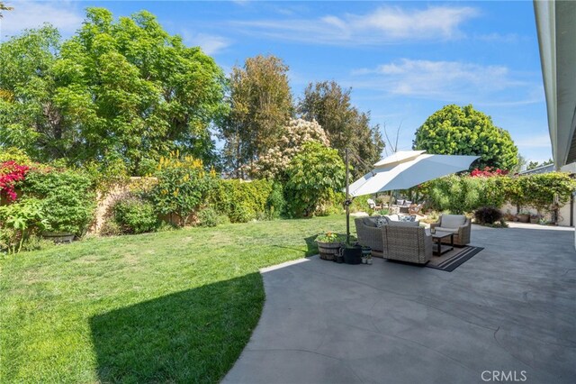 view of yard with fence, a patio, and outdoor lounge area