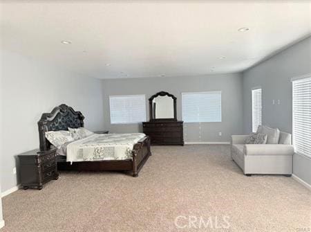 bedroom with recessed lighting, light colored carpet, and baseboards