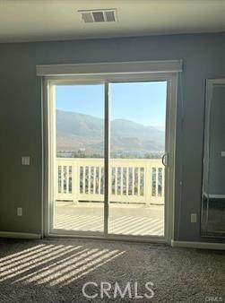 5491 N Pinnacle Ln, San Bernardino, CA 92407 - entryway featuring a mountain view, carpet, and baseboards