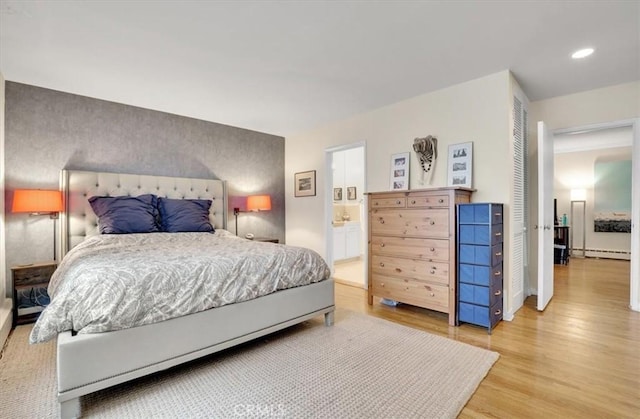 11767 W Sunset Blvd Unit 206, Los Angeles, CA 90049 - bedroom featuring light wood-type flooring, a baseboard heating unit, recessed lighting, ensuite bathroom, and baseboards