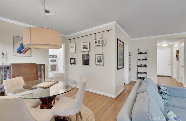 11767 W Sunset Blvd Unit 206, Los Angeles, CA 90049 - dining area with light wood-style flooring, baseboards, and ornamental molding
