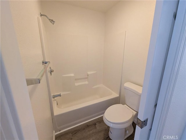 full bathroom with wood finished floors, toilet, and bathtub / shower combination