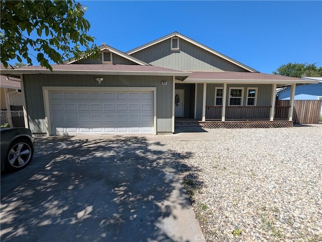 view of front of property featuring a porch, a garage, driveway, roof with shingles, and fence