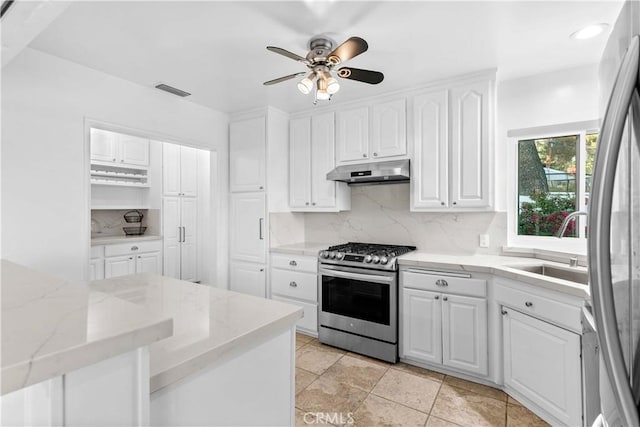 kitchen featuring a sink, tasteful backsplash, stainless steel appliances, and under cabinet range hood
