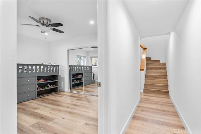 hall with recessed lighting, stairs, wood finished floors, and baseboards