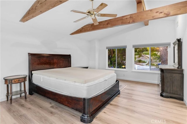 bedroom with wood finished floors, lofted ceiling with beams, and baseboards