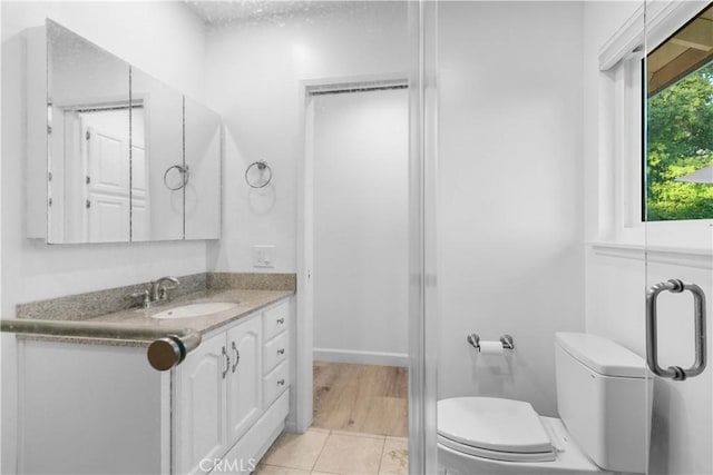 bathroom featuring vanity, toilet, and tile patterned flooring