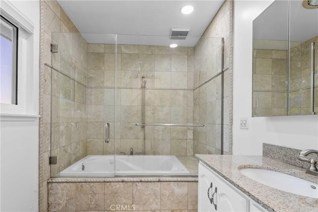 full bathroom with tiled shower / bath, visible vents, vanity, and recessed lighting