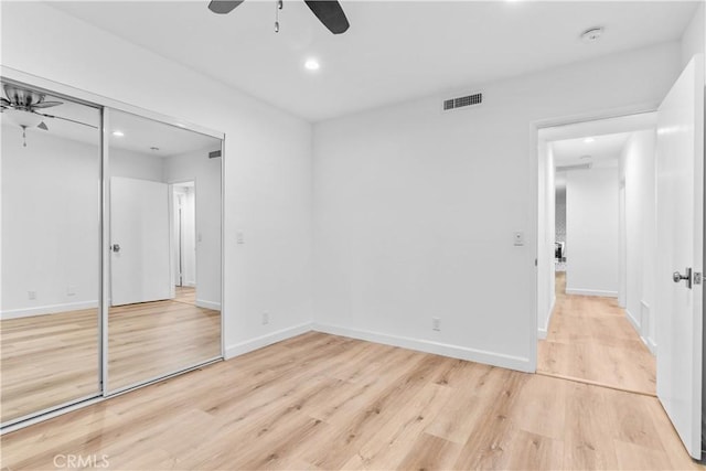 unfurnished bedroom with recessed lighting, a closet, light wood-type flooring, visible vents, and baseboards