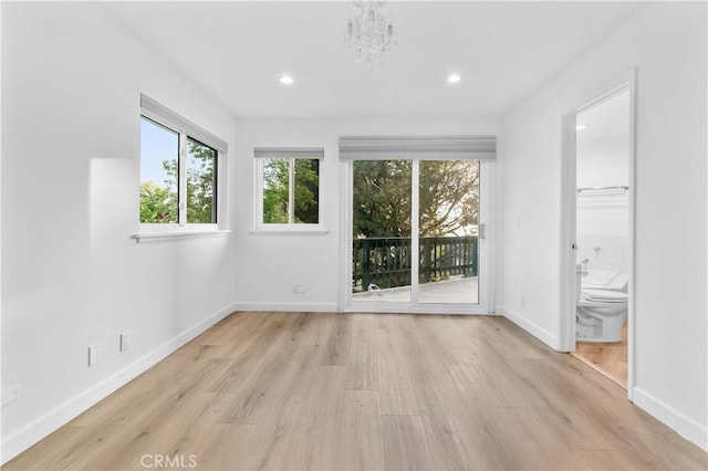interior space with recessed lighting, a notable chandelier, baseboards, and light wood-type flooring