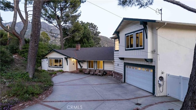 view of front of property with concrete driveway and a garage