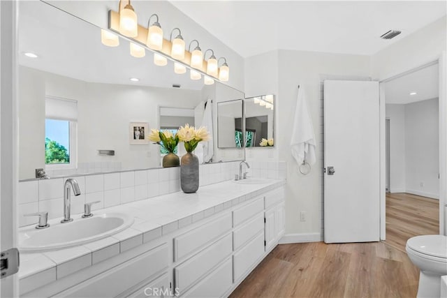 2320 Jayma Ln, La Crescenta, CA 91214 - bathroom featuring wood finished floors, double vanity, recessed lighting, and decorative backsplash