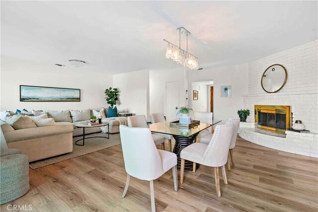 2320 Jayma Ln, La Crescenta, CA 91214 - dining space with wood finished floors, a chandelier, and a fireplace