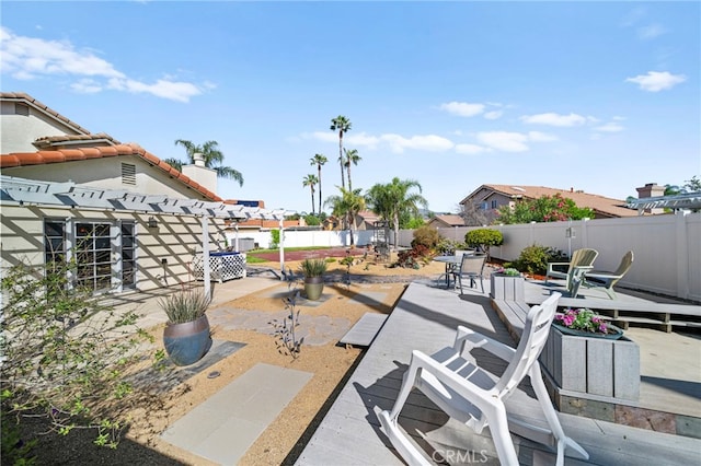 exterior space with a deck, a pergola, and a fenced backyard