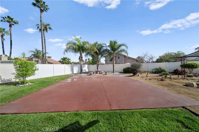 view of basketball court with a lawn and a fenced backyard