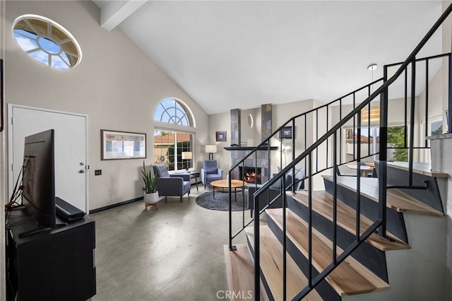 stairs featuring baseboards, high vaulted ceiling, beam ceiling, and concrete floors