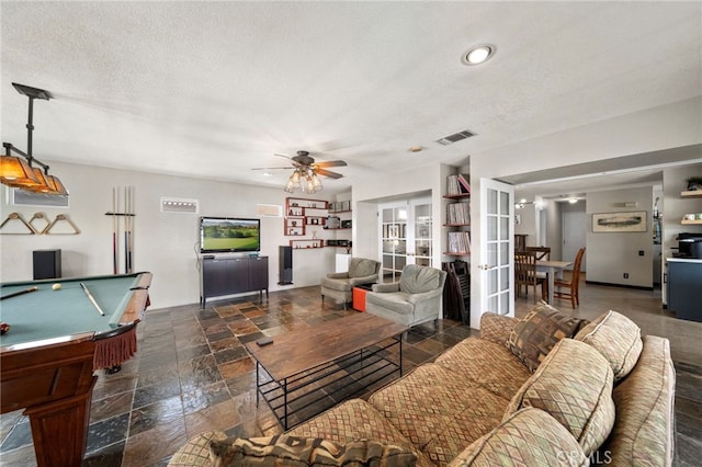 living area featuring billiards, visible vents, a ceiling fan, a textured ceiling, and french doors