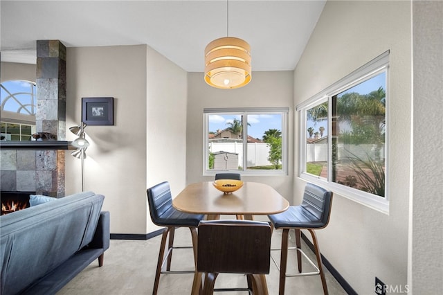 dining room featuring a fireplace and baseboards