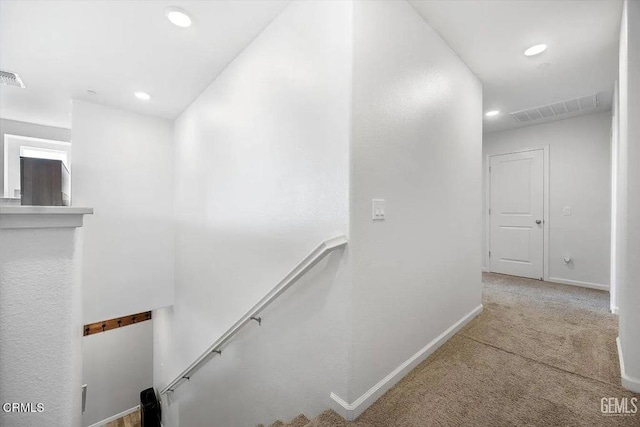 hall with recessed lighting, carpet floors, an upstairs landing, baseboards, and visible vents