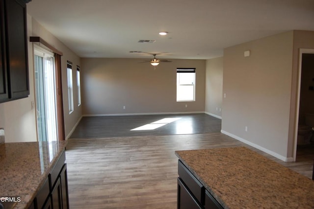 unfurnished living room featuring visible vents, ceiling fan, baseboards, recessed lighting, and wood finished floors