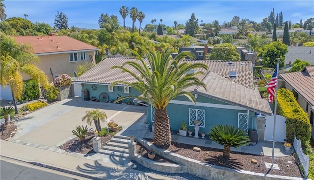 view of front of property with driveway, fence, a gate, a tiled roof, and stucco siding