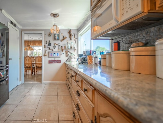 kitchen with light tile patterned floors, visible vents, ornamental molding, decorative light fixtures, and white microwave