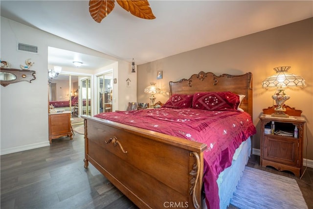 bedroom with vaulted ceiling, ceiling fan, baseboards, visible vents, and dark wood-type flooring