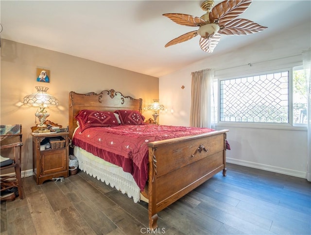 bedroom with dark wood-style flooring, a ceiling fan, and baseboards