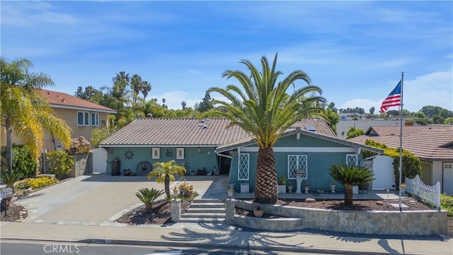 view of front of property with driveway and fence